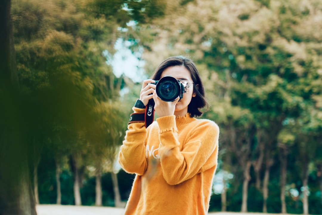 our-stories woman-holding-dslr-camera-toupbco62lw